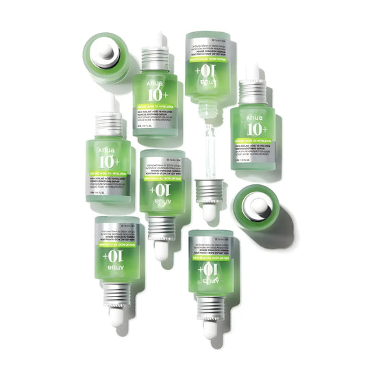 Clear glass bottles with green azelaic acid serum and silver dropper caps for Korean skincare and blemish-prone skin