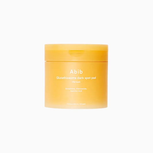 A vibrant orange abib glutathiosome dark spot pad jar with white labeling for brightening vitamin c toner use