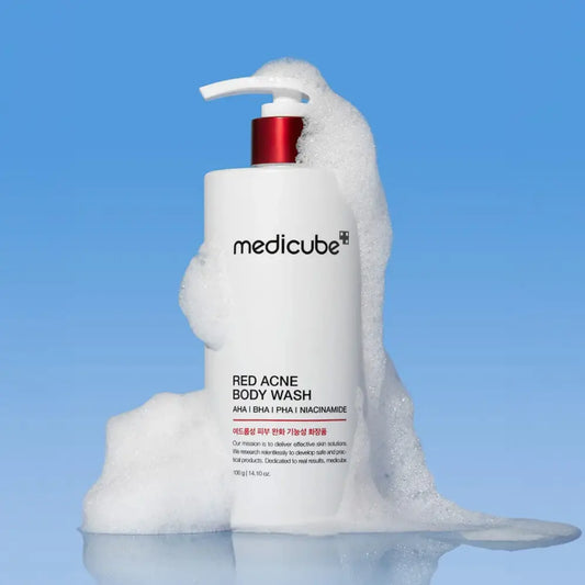 White pump bottle of medicube red acne body wash 400g with red accents and foamy texture for authentic k-beauty