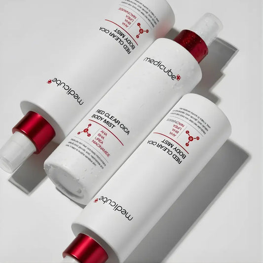Three white cylindrical bottles of medicube red clear cica body mist 200ml with red caps and spray nozzles