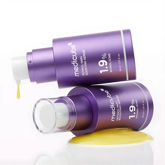 Two purple medicube retinol nmn boosting serum bottles with 1.9 percent retinol for improving skin texture
