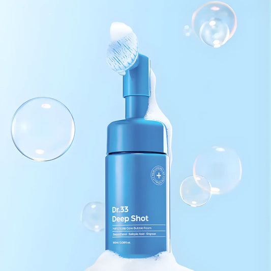 Scalpy bubble tonic 100ml in a sleek blue cylindrical bottle with pump dispenser and floating bubbles on light blue background