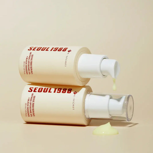 Creamy beige pump bottles of k-secret seoul 1988 serum with retinal liposome and black ginseng for korean skincare south africa