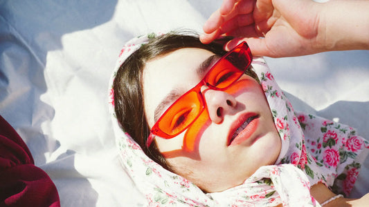 A pair of vibrant red-orange sunglasses complements the skin1004 hyalu-cica korean sunscreen article on viral sunscreens