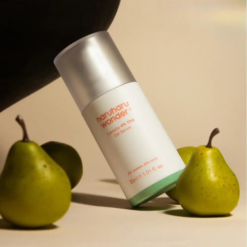 A sleek white and silver haruharu wonder 4% txa gel serum bottle with matte finish cap and minimalist orange text authentic k-beauty