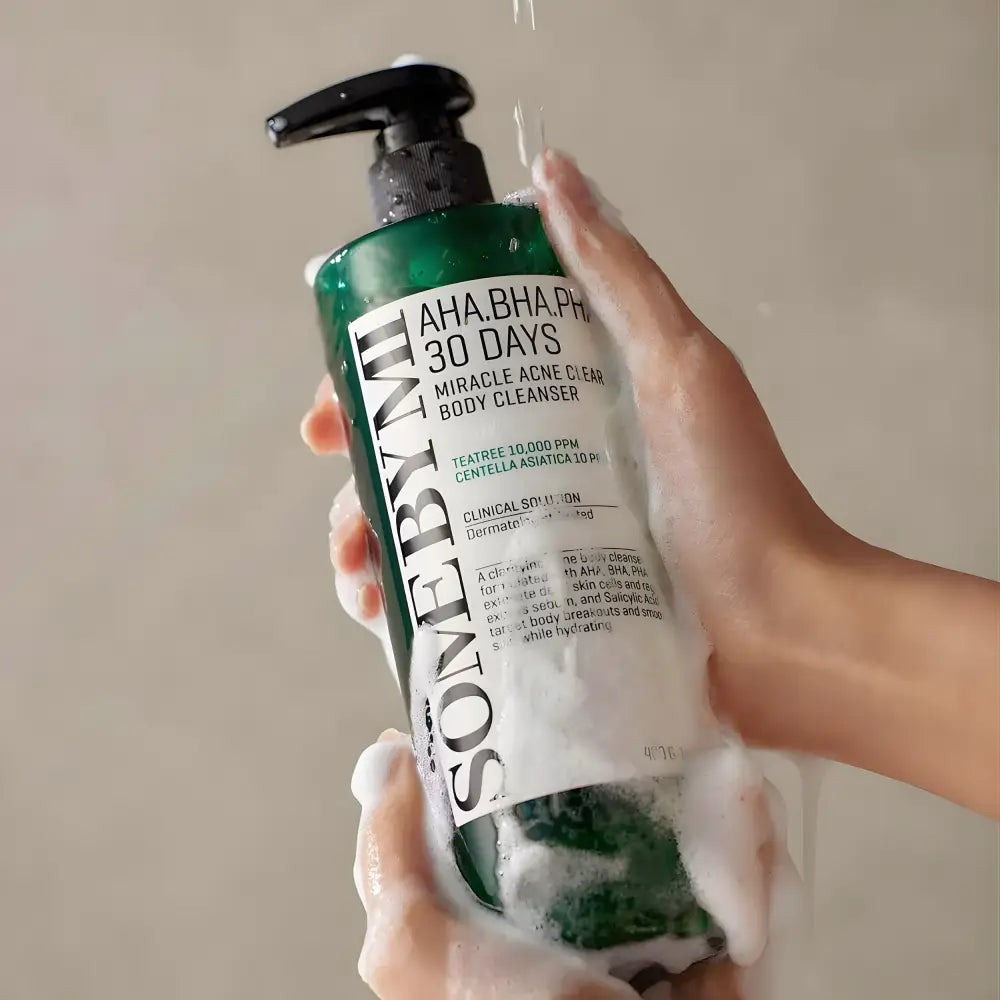 Green bottle of AHA BHA PHA 30 days miracle acne clear body cleanser with black pump and white label