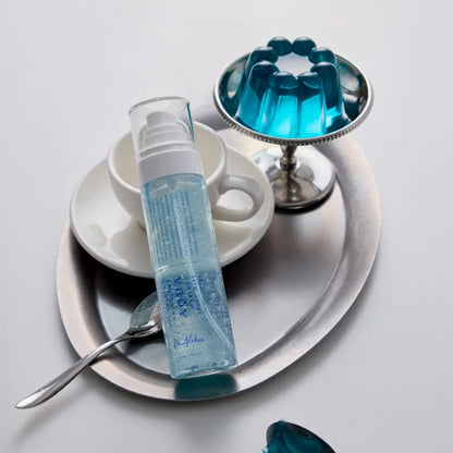 Transparent blue aqua marine jelly in a clear plastic bottle with white pump dispenser labeled marine jelly mist 100ml vegan pdrn