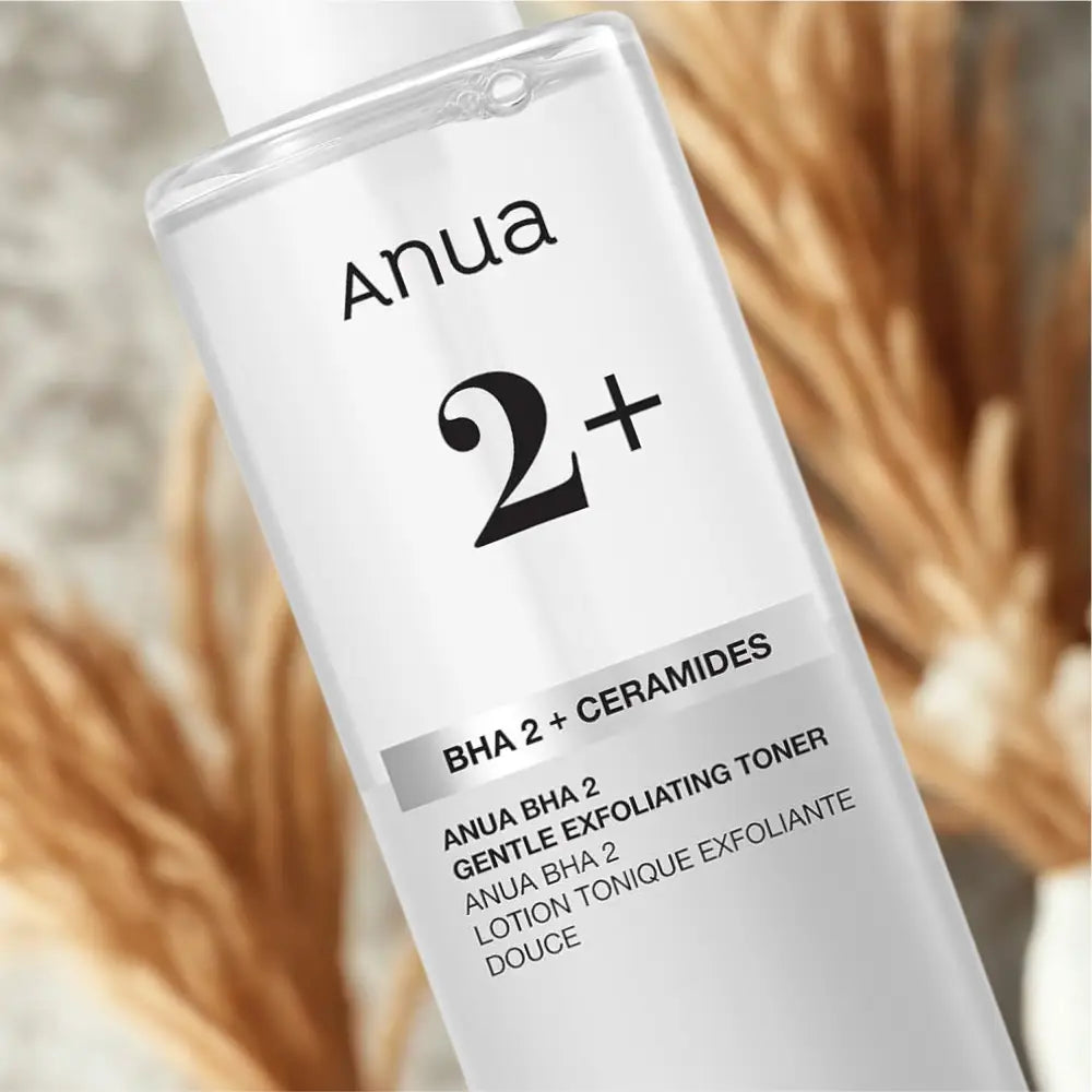 Clear glass bottle of anua bha 2 percent gentle exfoliating toner 150ml with white cap and minimalist black labeling containing salicylic acid