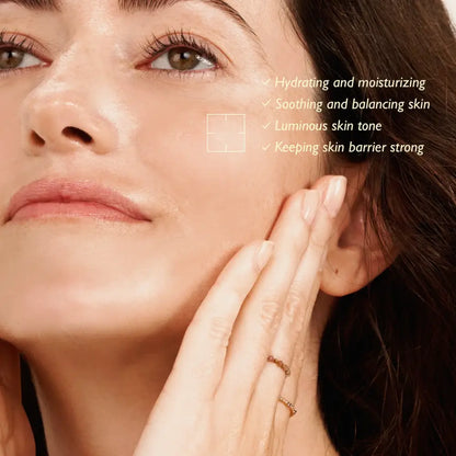 A woman gently touches her cheek with smooth radiant skin using black rice hyaluronic toner from authentic k-beauty south africa