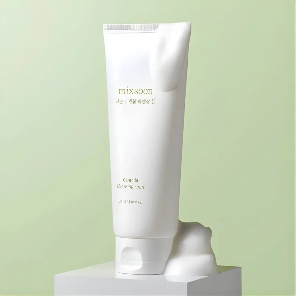 White tube of Mixsoon centella cleansing foam 150ml with minimalist gold lettering and soft frothy centella cleansing texture spilling