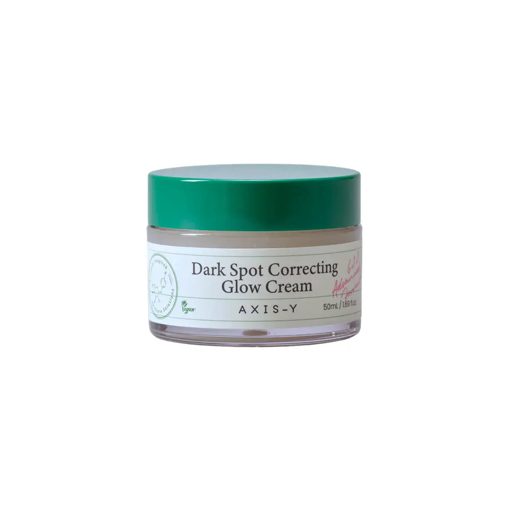 A clear glass jar with a green lid contains axis-y dark spot correcting glow cream with a white label for authentic korean skincare south africa