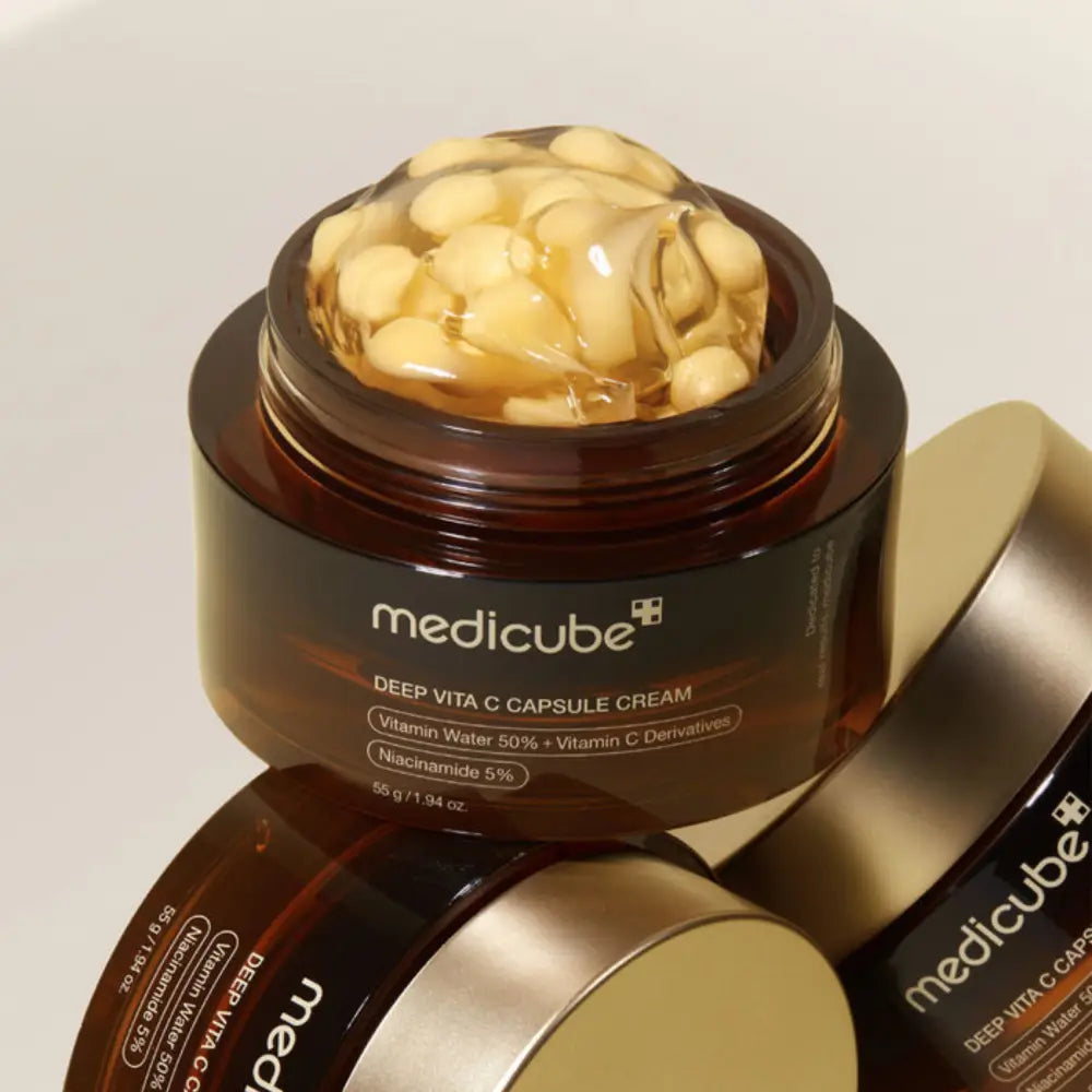 Medicube deep vita c capsule cream 55g in a dark brown jar with gold lid showing yellow vita c capsules in gel