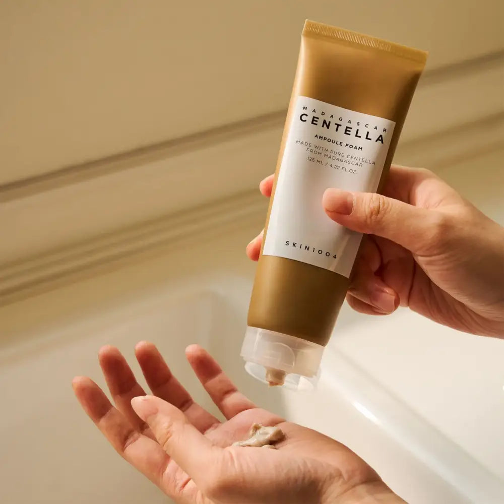 A gold-colored 125ml skin1004 Madagascar centella ampoule foam tube with a white label and clear flip-top cap
