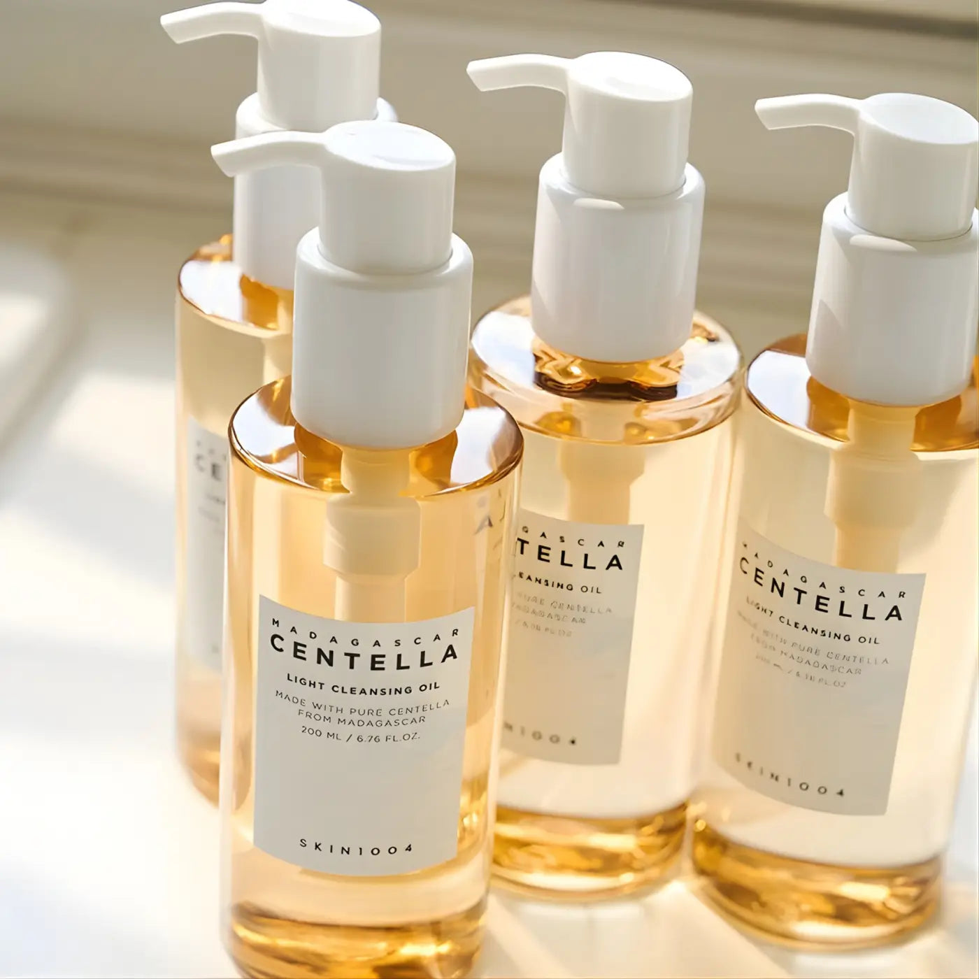 Clear glass bottles with white pumps of golden madagascar centella light cleansing oil by skin1004 best korean skincare brands sa