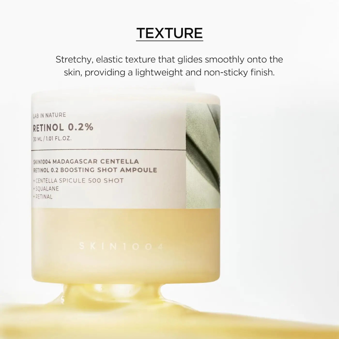 A sleek translucent amber glass bottle of madagascar centella retinol boosting shot ampoule 30ml with minimalist label