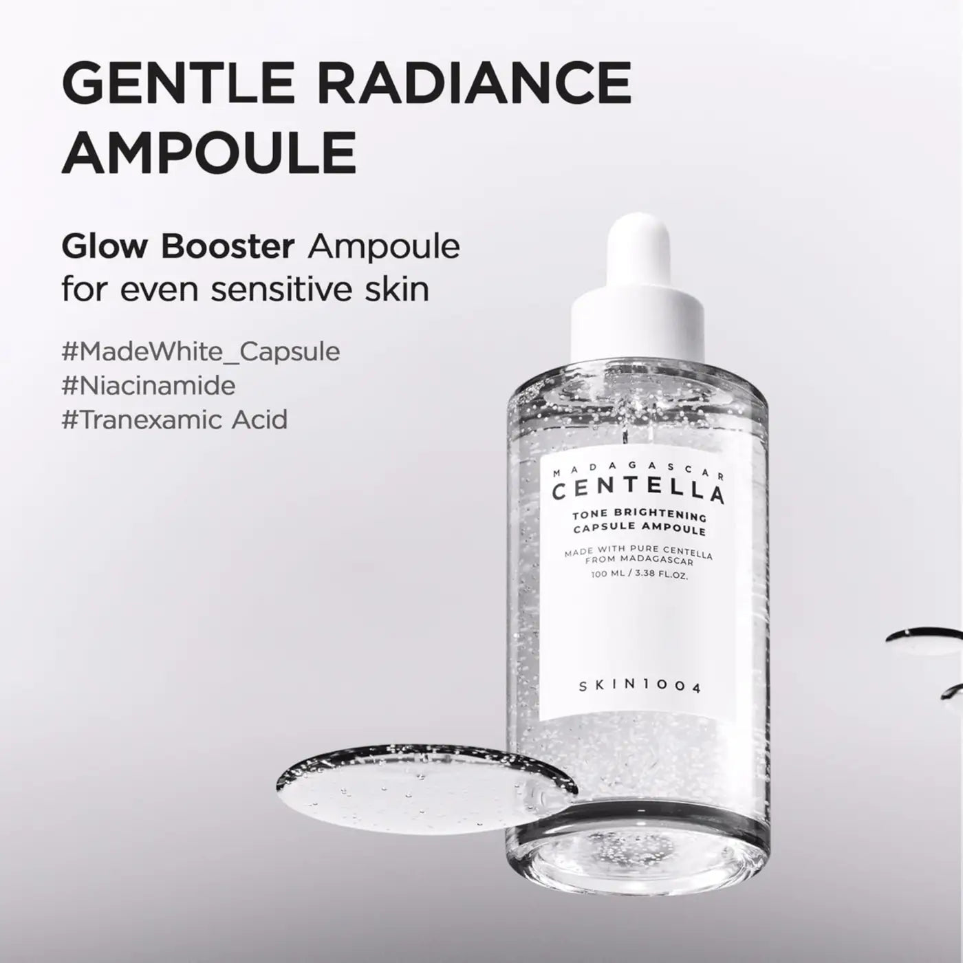 Clear glass bottle with white dropper cap containing transparent madagascar centella tranexamic acid brightening capsule ampoule