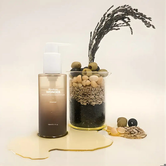 A sleek gradient brown glass bottle with white pump labeled manhattan wonder moisture cleansing oil unscented 150ml authentic k-beauty