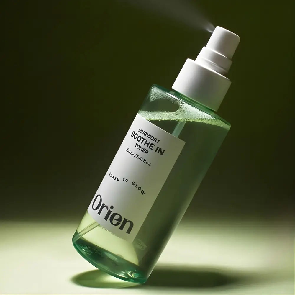 A clear glass bottle with a white spray nozzle containing green mugwort soothe toner by orien from the best korean skincare brands sa
