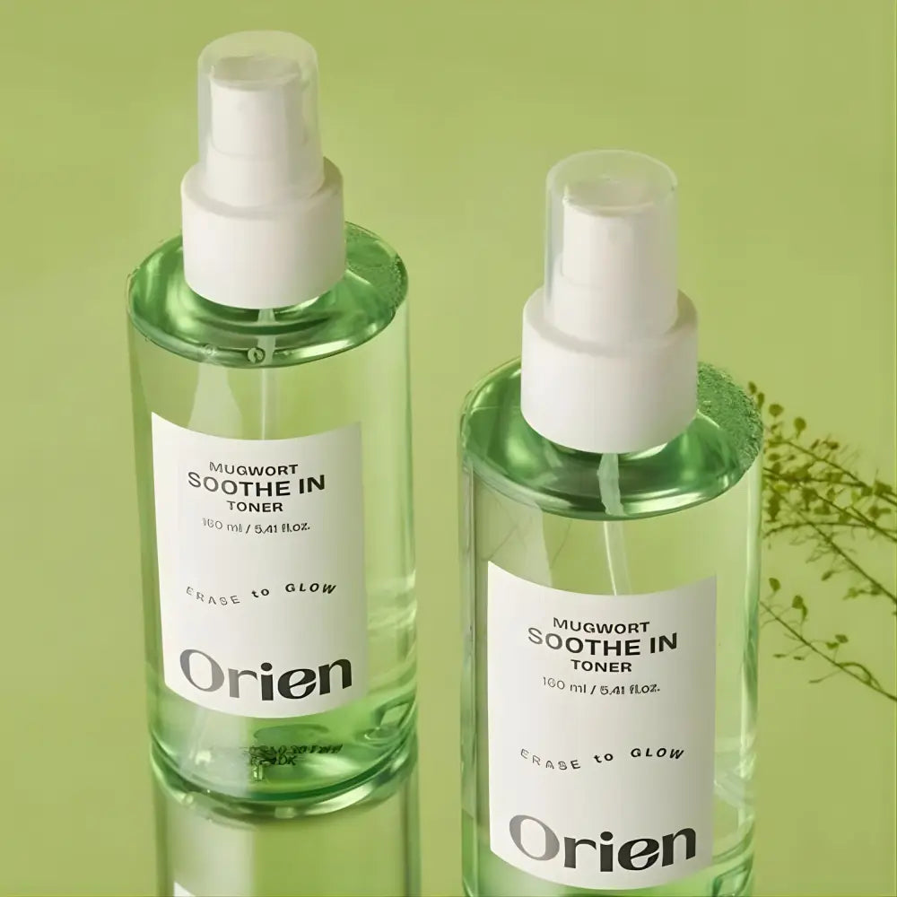 Two clear glass bottles of mugwort soothe in toner 160ml with white spray nozzles and light green liquid from the seoul palette