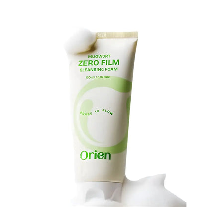 White tube of mugwort zero film cleansing foam 150ml with green text and fluffy white cotton ball on top
