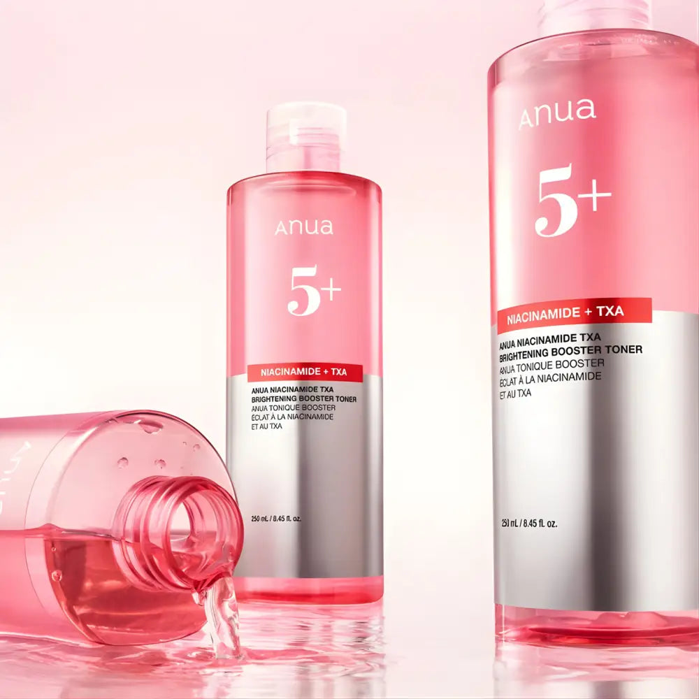 Pink anua niacinamide txa brightening booster toner 250ml in clear glass bottles with silver labels for brightening skin