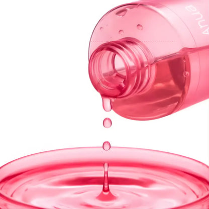 A translucent pink plastic bottle pouring vibrant pink liquid of niacinamide txa brightening booster toner 250ml