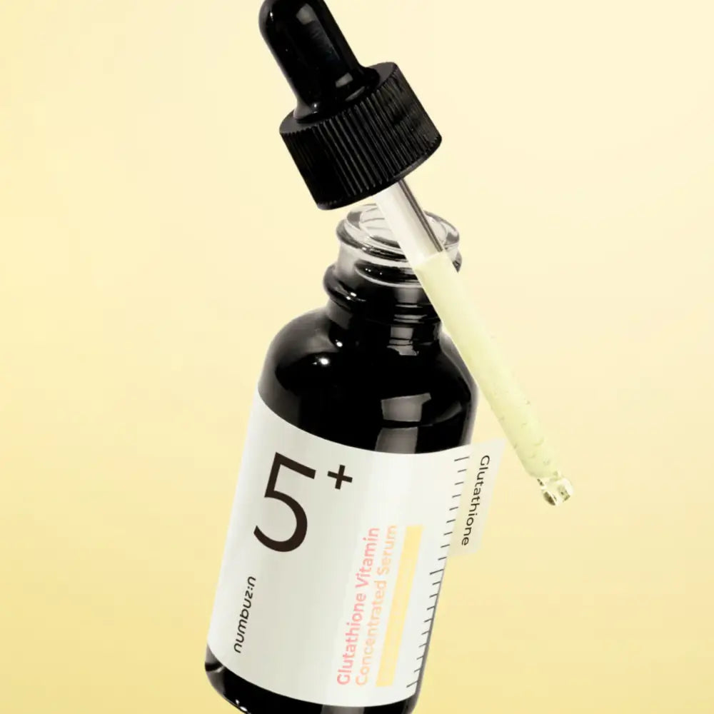 Black glass bottle with white label and dropper containing no.5+ glutathione vitamin concentrated serum for dark spots