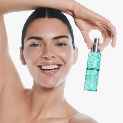 A translucent turquoise bottle with a silver pump of aqua pore hydration pdrn collagen glow serum spray 100ml