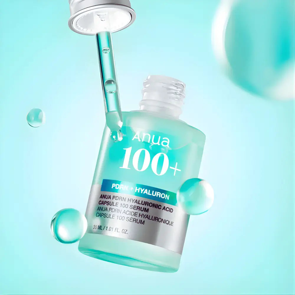 A translucent teal glass bottle of anua pdrn hyaluronic acid capsule 100 serum with silver dropper cap 30ml