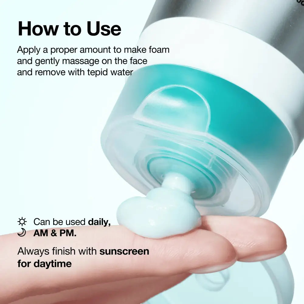 A sleek teal pump bottle of pdrn hyaluronic acid moisturizing cleansing foam dispenses light blue foaming cleanser