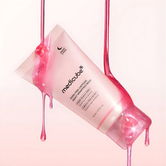 A translucent pink tube of medicube pdrn pink caffeine night-wrapping mask 75ml with product droplets on sides