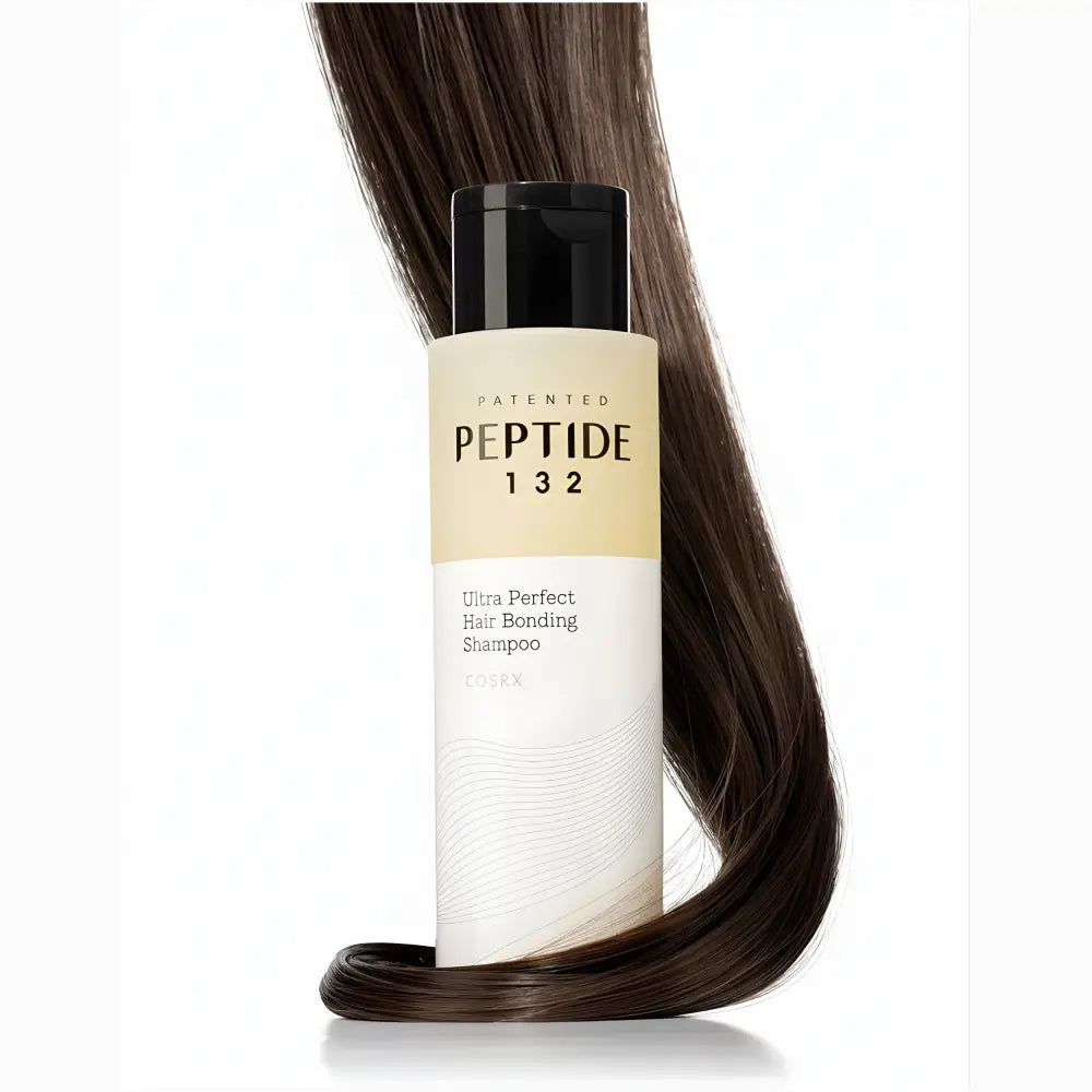 A sleek transparent bottle of cosrx peptide 132 ultra perfect hair bonding shampoo with black cap and minimalist label design