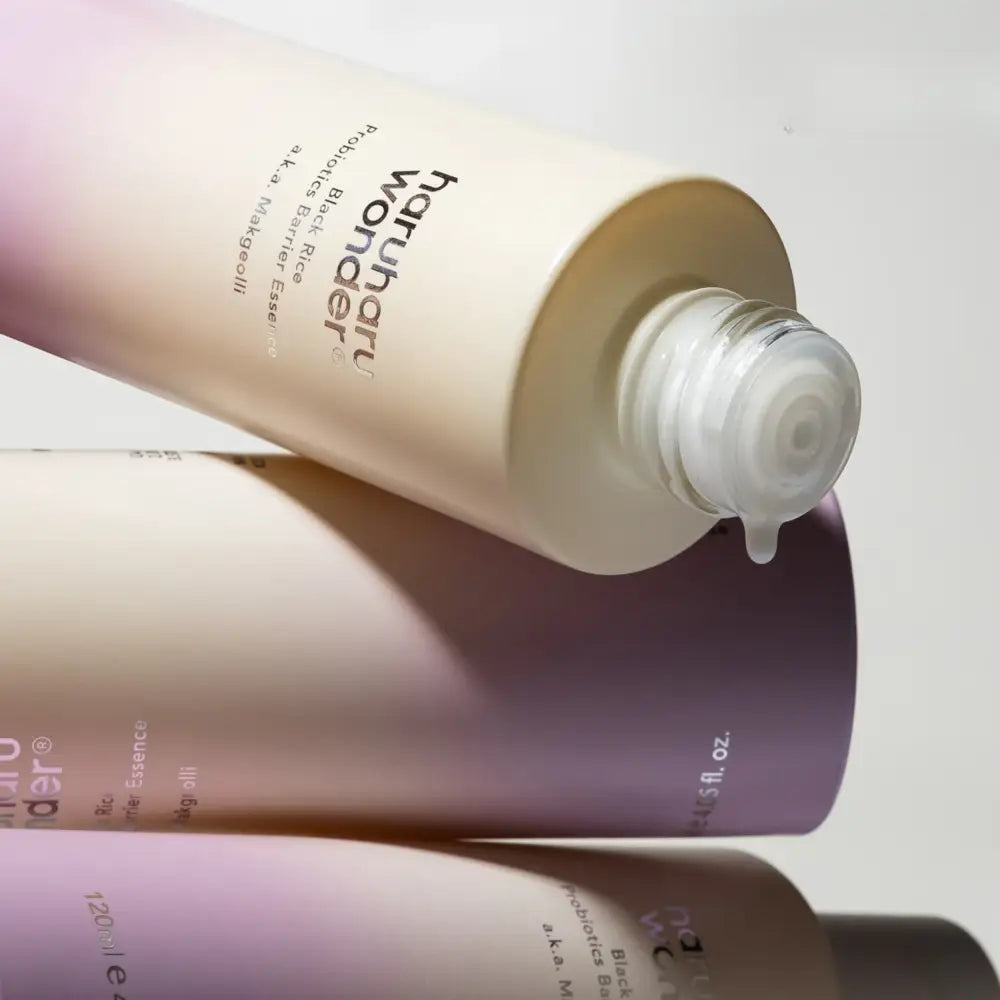 Cream-colored cylindrical bottle of haruharu probiotics barrier essence with clear pump for authentic k-beauty skincare