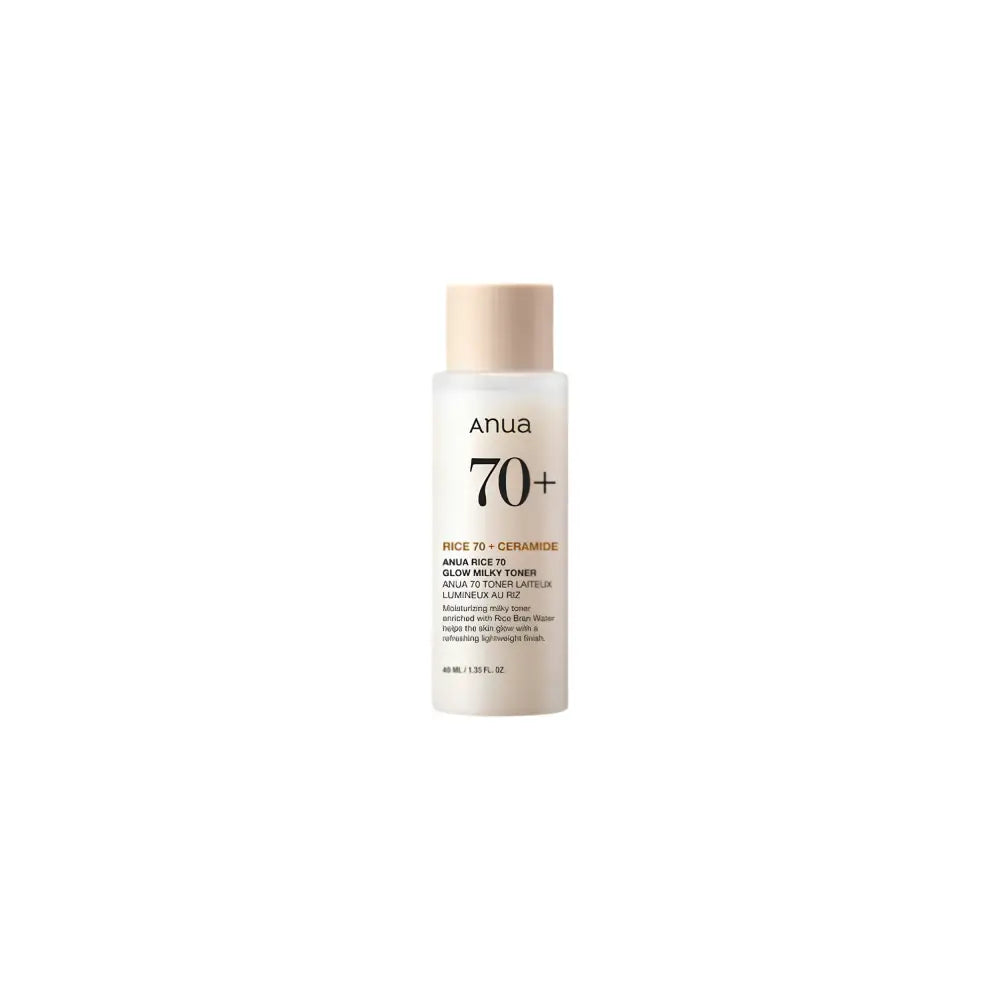 A sleek transparent bottle with beige cap and minimalist label of anua rice glow milky toner for skin barrier