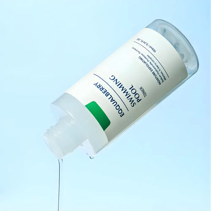 A clear glass bottle with white label and green accent featuring equalberry swimming pool moisture exfoliating toner for skin
