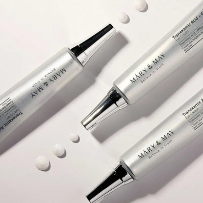 Three sleek silver tubes of mary & may tranexamic acid glutathione eye cream with black caps and metallic accents 30ml