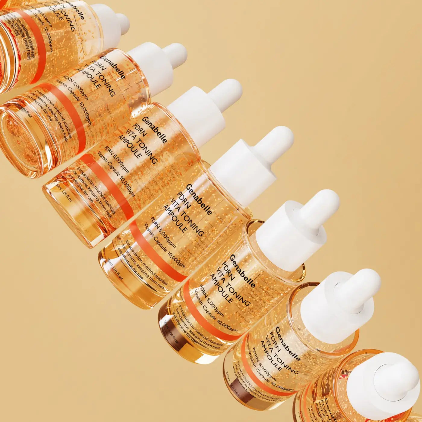 Clear glass bottles with white dropper caps filled with golden-orange genabelle vita toning pdrn ampoule 30ml