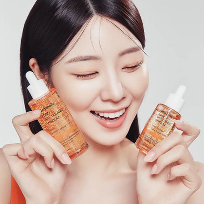 Orange glass dropper bottles with white caps labeled genabelle vita toning pdrn ampoule 30ml for skincare use