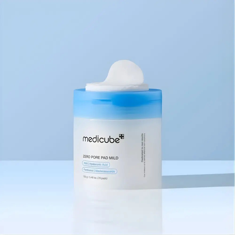 A translucent white cylindrical medicube zero pore pad mild container with a blue lid and white pad dispenser